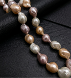 Pearl necklace on a black textured surface
